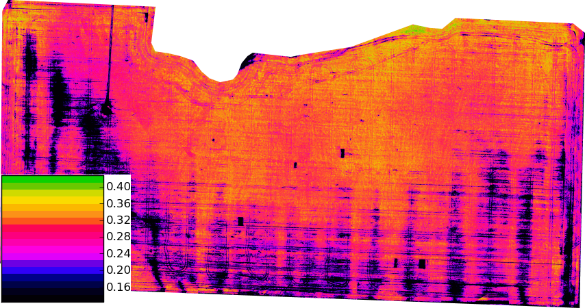 A false-colour vegetation index map of a roughly rectangular farm field seen from directly above, mostly orange and pink with dark streaks and blotches running in parallel rows across it and along its left edge. A stepped colour key at the lower left is labelled with index values from 0.16 at the bottom to 0.40 at the top.